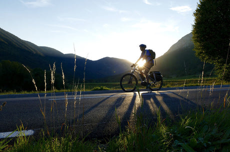 a man with a backpack rides an electric bicycle